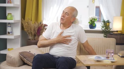 Sick old man with rapid breathing. The old man cannot control his breathing.