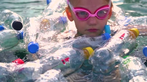 Plastic waste floating in the ocean. Plastic pollution trash in ocean.
