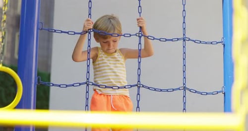 Child Climbing Playground Net in Summer