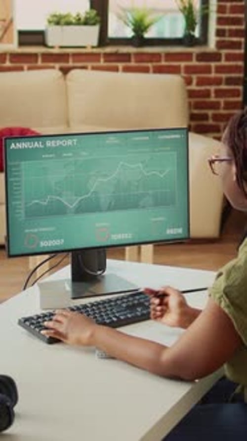 Vertical Video Office Worker Checking Diagrams Report and Taking Notes