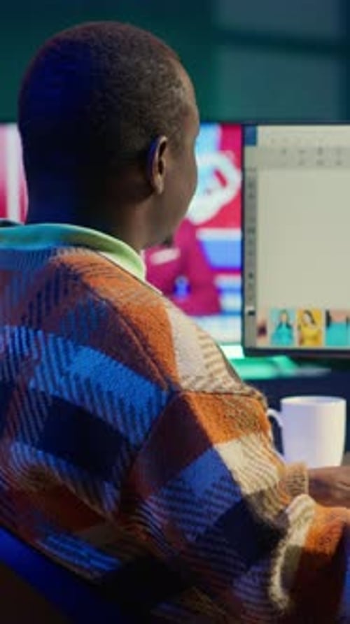 Man Looks at Photo Editing Application on Computer