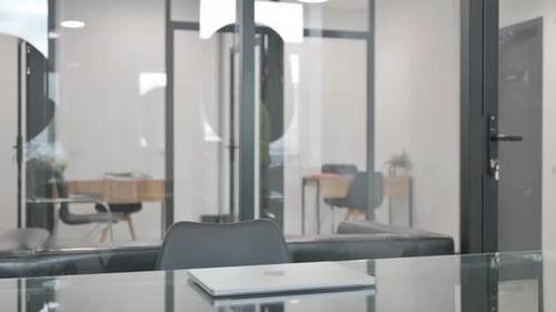Man Opens Laptop at Modern Office Desk