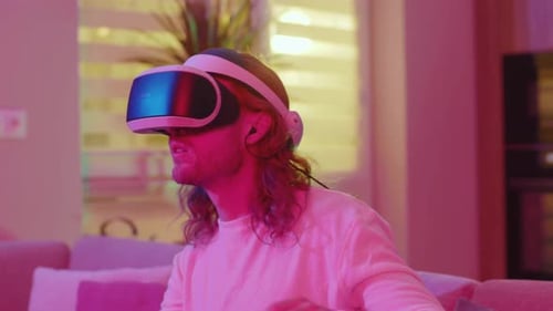 Young Adult Immersed in Virtual Reality Headset at Home