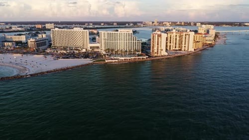 Clearwater Beach resorts and curved shoreline along Gulf waters — aerial perspective