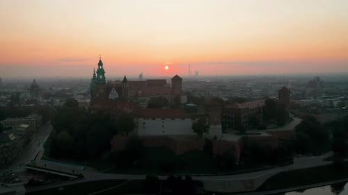 Drone footage of Wawel Royal Castle at magic dawn with soft, morning sunlight, Krakow, Poland