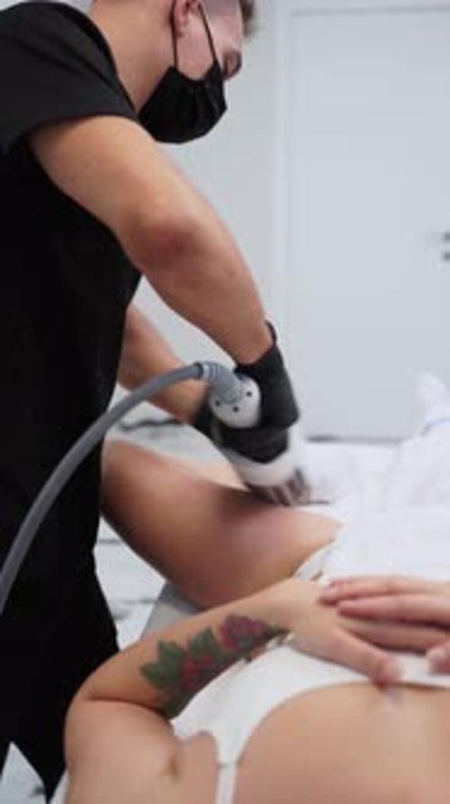 Therapist Performs Endospheres Therapy Massage on Clients Thigh to Reduce Cellulite in Modern Clinic