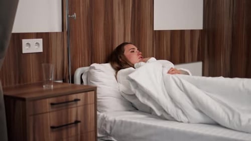 in Modern Clinic in a Bright VIP Room Lies Young Girl in a White Coat with a Cold Medical Care