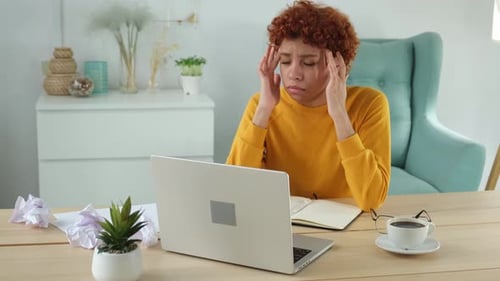African Woman Touching Temples Experiencing Stress