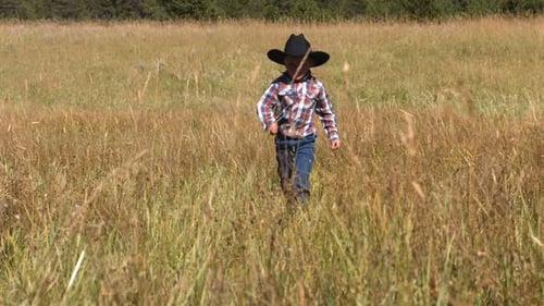 Young Cowboy Runs In Grassy Field, Slow Motion