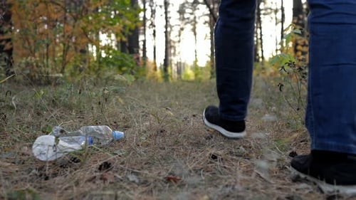Adult Male Pollutes Forest By Discarding Bag of Garbage