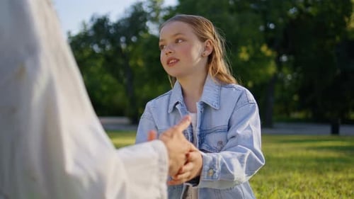 Small Girl Playing Mother at Sunny Grass Picnic Closeup Mom Kid Clapping Hands