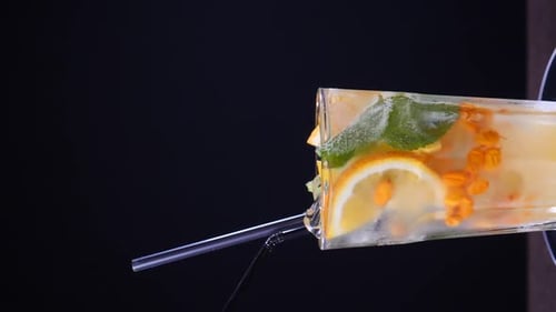 Refreshing Iced Cocktail with Orange and Berries