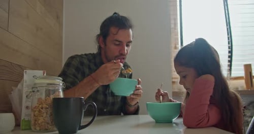 Brunette Man in a Green Checkered Shirt the Single Father Has Breakfast with His Little Daughter a