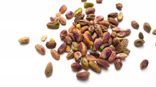 Fresh Healthy Pistachio Nuts Slide View On White Table Background