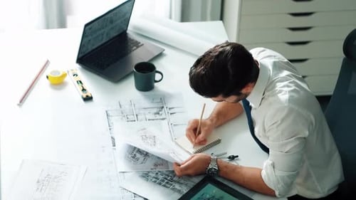 Architect engineer using laptop planning house design at office. Alimentation.