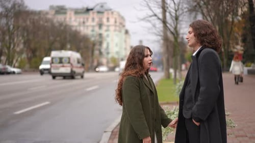 A Loving Couple Enjoying a Joyful Moment Together While Strolling on a Busy City Street