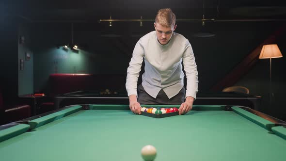 Young Man Arranging Billiard Balls in Triangle Formation on Green Pool ...
