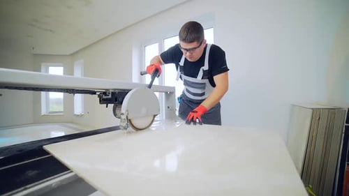 Construction Worker Using Wet Tile Saw in Home