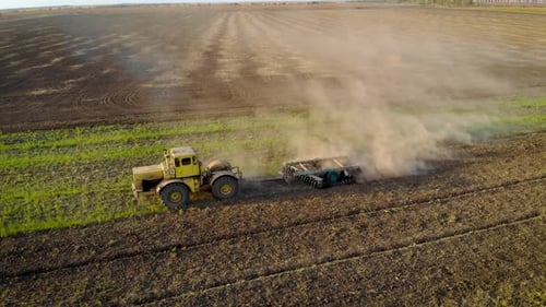 Aerial View of Cultivation of Farmland By Disc Harrows Close Up