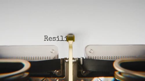 Old mechanical typewriter typing Resilience Building in a close-up view.