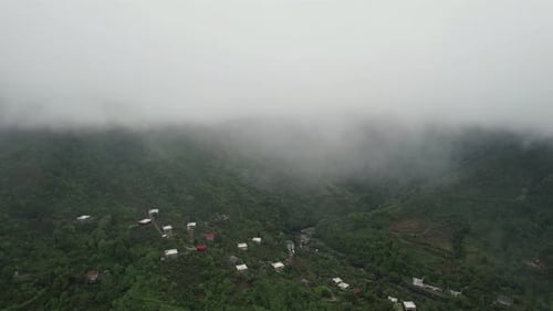 Clouds Descend On The Mountains. Green Mountains Aerial Background. Village In The Mountains
