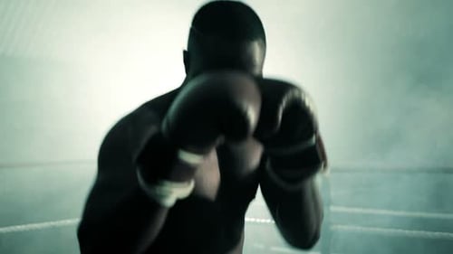 Muscular Man Boxing in Smoky Ring with Gloves