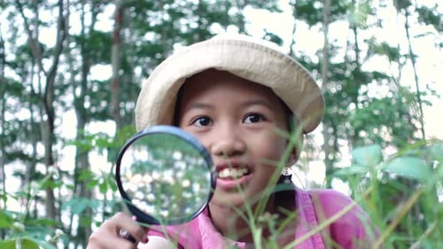 Girl Exploring Nature with Magnifying Glass