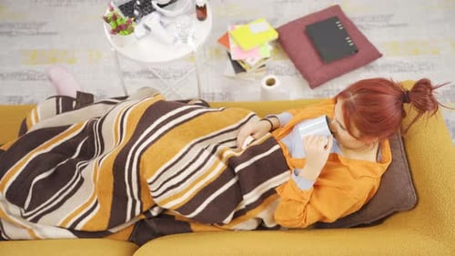 Woman Sick with Flu Lying on Sofa at Home