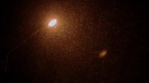 City lights on a frosty winter night, snow storm, warm light