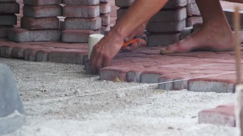 Man Laying Patio Stones with Mallet