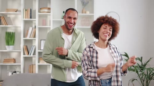 Cheerful Couple Dancing Together at Home