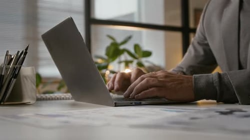 Hands of Unrecognisable Male Manager Typing on Laptop at Office Table