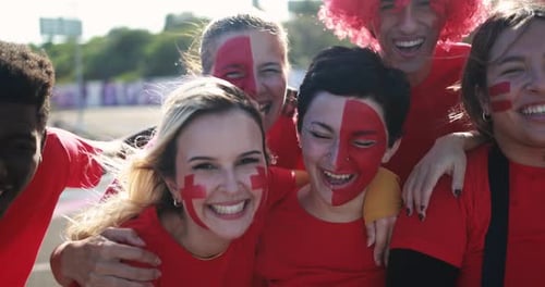 Enthusiastic young adults with face paint smile outdoors