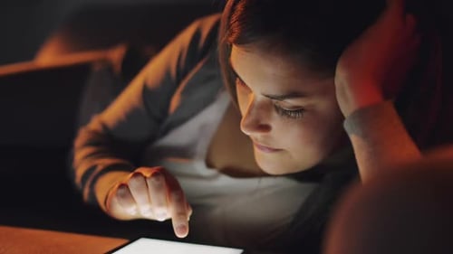 4k video footage of a woman using a digital tablet at home
