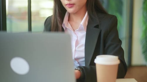 A beautiful business woman is analyzing financial data via computer