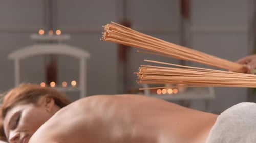 Woman Receiving Bamboo Massage in Calm Spa Setting