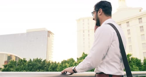 4k video footage of a handsome young businessman using a mobile phone in the city
