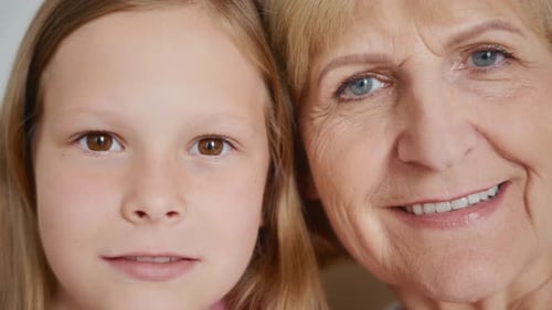 Girl and Senior Woman Smiling Close Up