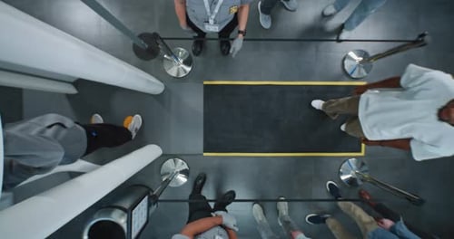 Top View on Queue of Diverse People Passengers Passing Through Xray Metal Detector Scanner Gates