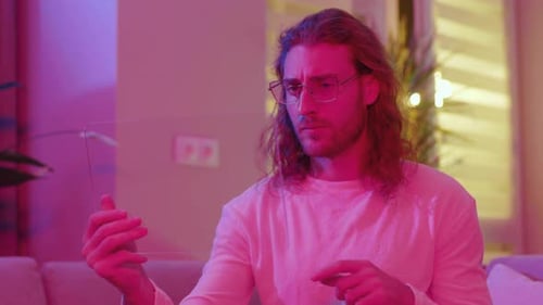 Man Interacts with Futuristic Transparent Tablet at Home