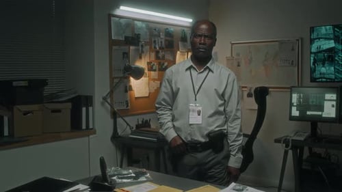 Portrait of Mature Black Male Detective Investigating Case in Office