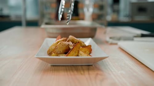 Seasoned Potato Wedges Being Served on a Plate
