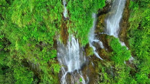 Beautiful waterfall in a tropical forest by aerial view from a drone.