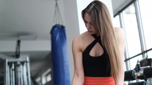 Woman Lifting Weights at the Gym