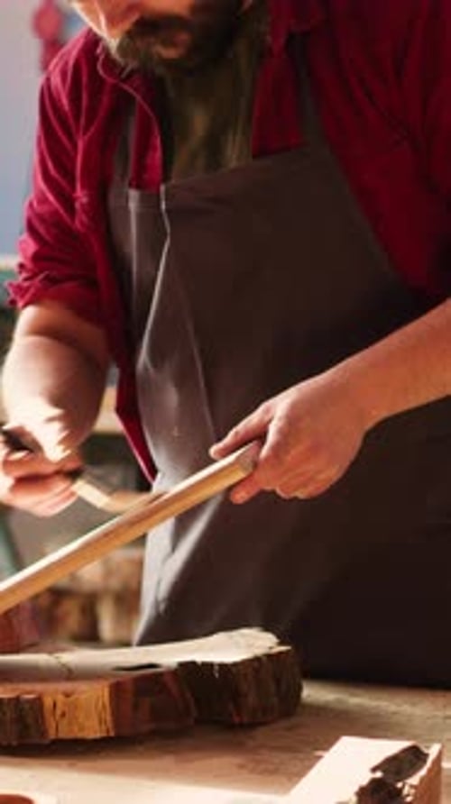 Vertical Video Woodworking Expert in Studio Doing Putting Coats of Oil on Wood Plank