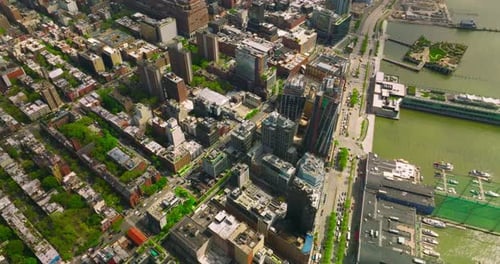 Beautiful quarters of Manhattan island near the river bank. Top view of the city with busy traffic.