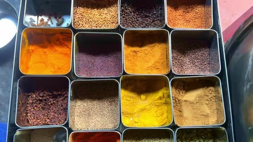 Varied Culinary Spices in a Compartment Container