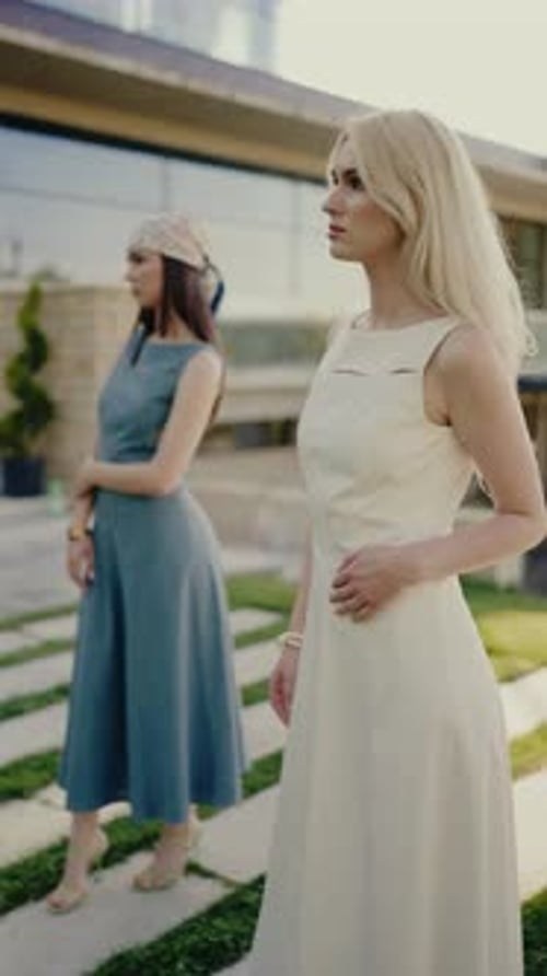 Two Attractive Women Posing Outdoors on Sunny Day