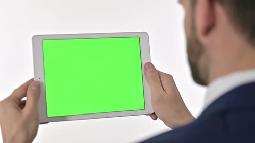 Man Holding Tablet with Green Screen Display