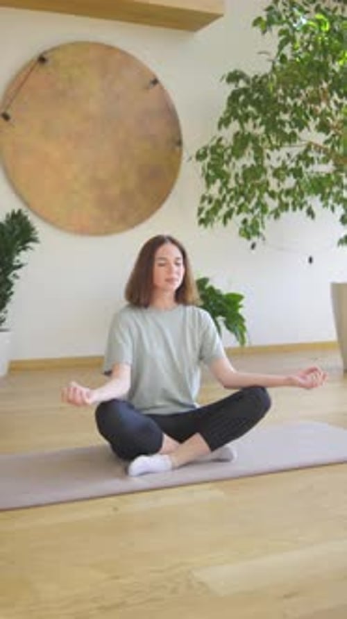 A Young Woman Finds Tranquility While Meditating Amidst Plants Aiming for Inner Peace Through a